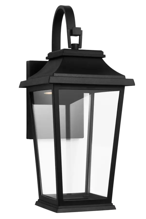 The Warren Small Wall Lantern combines traditional lantern styling with a modern textured black finish. Its compact size makes it ideal for flanking doorways or illuminating smaller outdoor spaces with classic charm. - alternate view