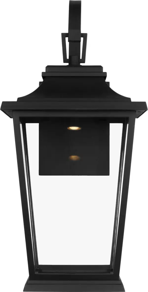 The Warren Medium Wall Lantern combines traditional lantern styling with a modern textured black finish. Its medium scale makes it versatile for various outdoor applications, from residential entryways to commercial facades.