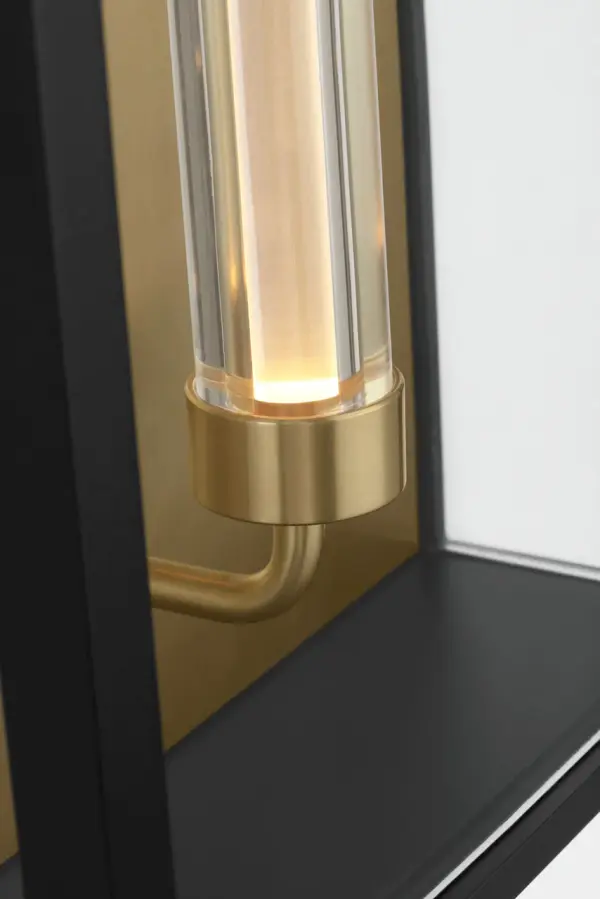 The Enferme 29" Wall Sconce delivers striking architectural presence with its elongated 29-inch profile and layered glass construction. Integrated LED mimics Edison warmth while Hand-Rubbed Antique Brass details add refined contrast to the Outdoor Black finish. - alternate view