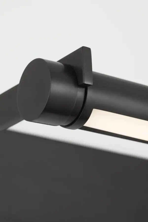 The Katan picture light combines minimalist design with practical functionality, featuring a pivoting cylinder light source within a contrasting rectangular frame. Its 2700K warm LED and 90 CRI provide museum-quality illumination. - alternate view