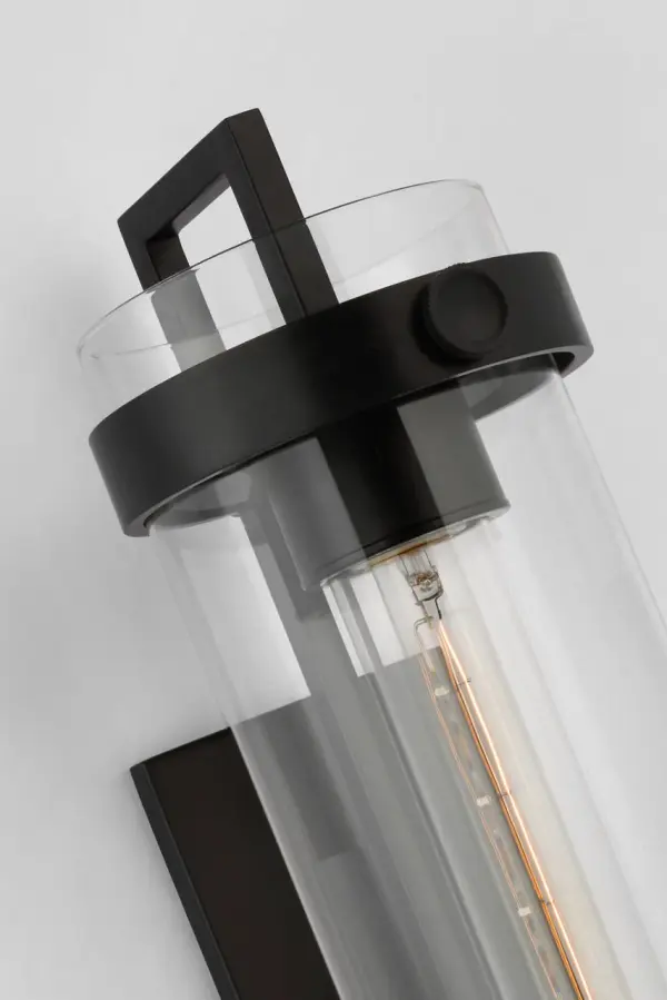 The Kears by Ian K. Fowler features a distinctive design with suspended light sources within aged iron rings and clear glass cylinders, creating an airy aesthetic perfect for both indoor and outdoor applications. - alternate view