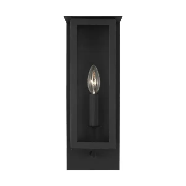 The Dresden outdoor wall sconce reimagines the traditional lantern with a contemporary architectural approach. Designed by Thom Filicia, it features a textured black finish and linen shade that softens the light, creating a refined yet relaxed aesthetic perfect for modern exteriors.