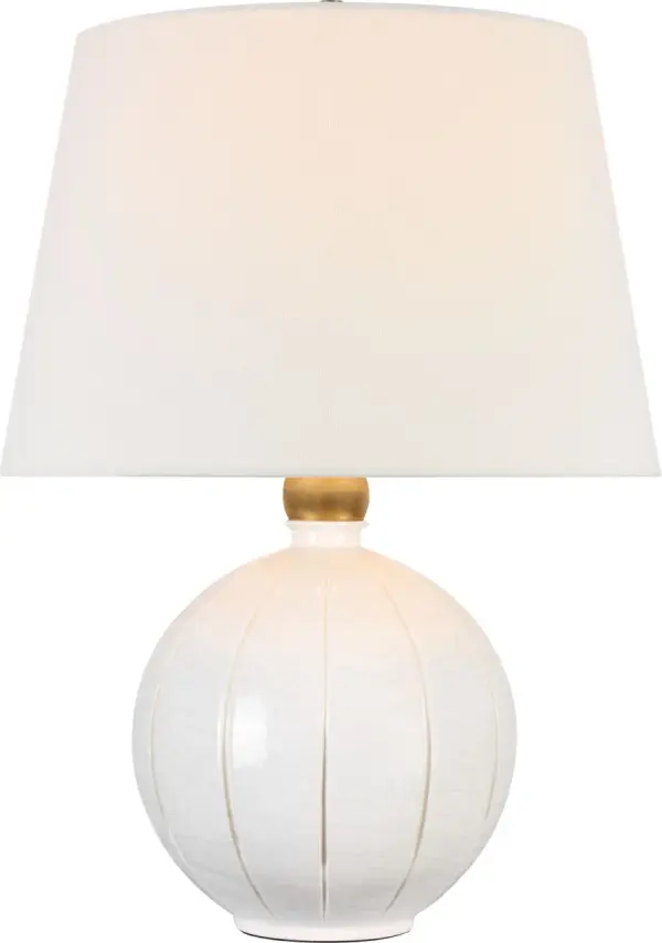 The Ponteil table lamp combines a sophisticated crackled ivory ceramic base with a classic linen shade, creating a versatile lighting solution that bridges traditional and contemporary design sensibilities.