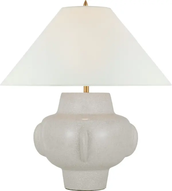 The Cap-Ferrat table lamp brings sophisticated coastal charm with its distinctive white crackle ceramic base and classic linen shade. At 26 inches tall, it provides substantial presence while maintaining versatility across traditional and transitional interiors.
