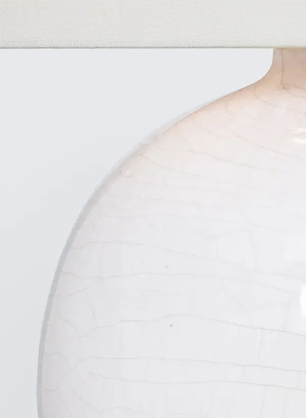 The Sao Paulo table lamp features a sophisticated crackled ivory ceramic base paired with a classic linen shade. At 21" tall, it provides ideal task and ambient lighting for bedrooms and living spaces with transitional or coastal design. - alternate view