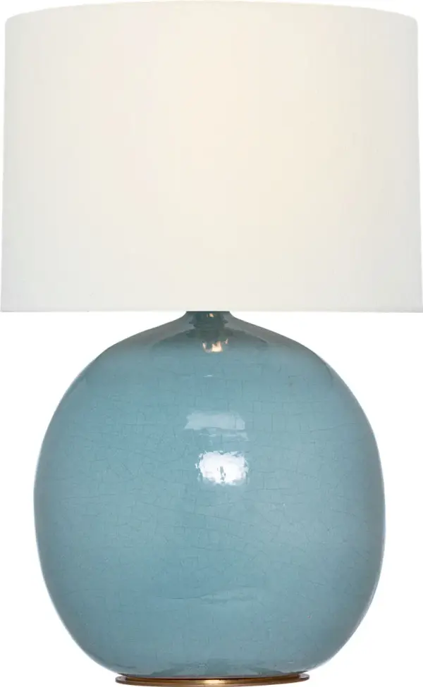 The Sao Paulo table lamp features a distinctive crackled robin's egg blue ceramic base paired with a classic linen shade. At 29" tall, it provides substantial presence while maintaining versatility across traditional and contemporary interiors.