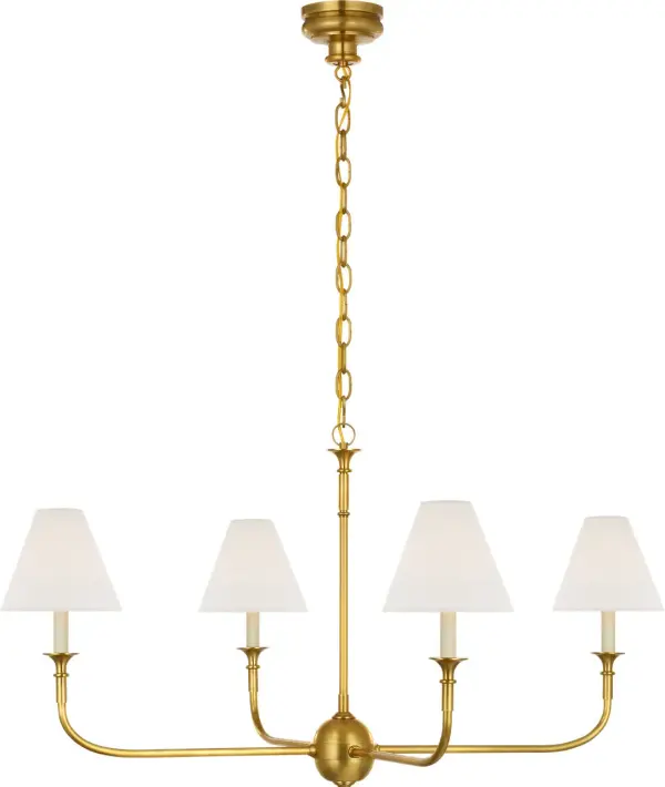The Piaf Large Chandelier combines classic hand-rubbed antique brass metalwork with a sophisticated linen shade, creating warm, diffused lighting perfect for formal dining rooms and grand entryways.