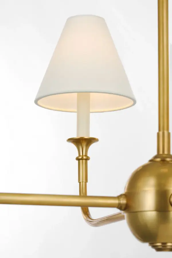 The Piaf Large Chandelier combines classic hand-rubbed antique brass metalwork with a sophisticated linen shade, creating warm, diffused lighting perfect for formal dining rooms and grand entryways. - alternate view