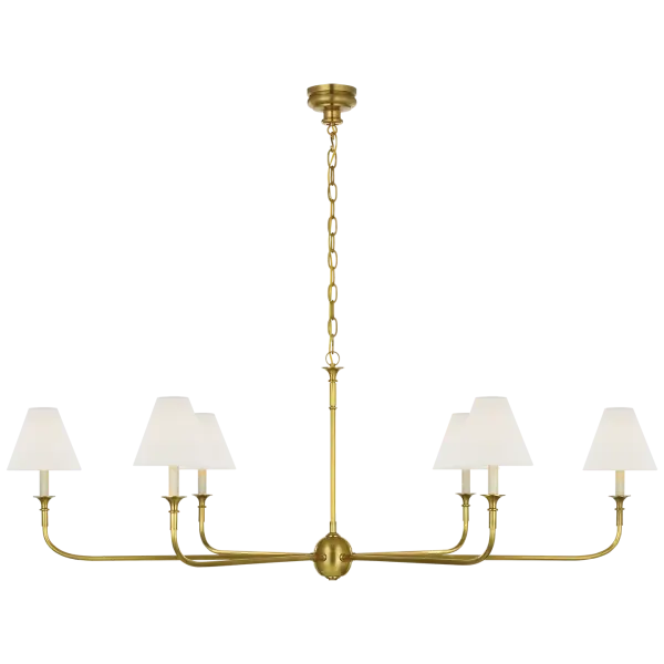 The Piaf Grande brings sophisticated illumination to spacious interiors with its hand-rubbed antique brass frame and soft linen shades. This substantial chandelier balances traditional craftsmanship with transitional design.