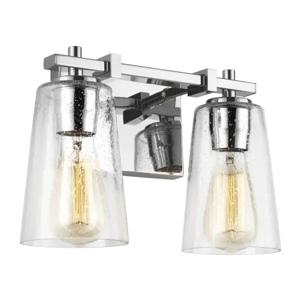 Sean Lavin's Mercer vanity fixture delivers modern sophistication with its sleek rectangular backplate and square cross arm supports. The clear seeded glass shades add subtle texture while the chrome finish brings bright, reflective elegance to bath spaces.