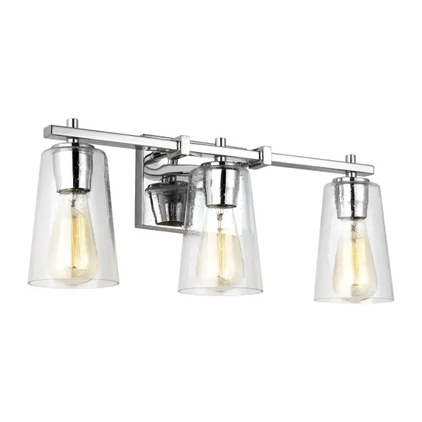 The Mercer vanity fixture by Sean Lavin delivers contemporary style with functional shadow-free lighting. Clean square supports and a sleek rectangular backplate create a tailored look, while clear seeded glass shades add subtle texture.