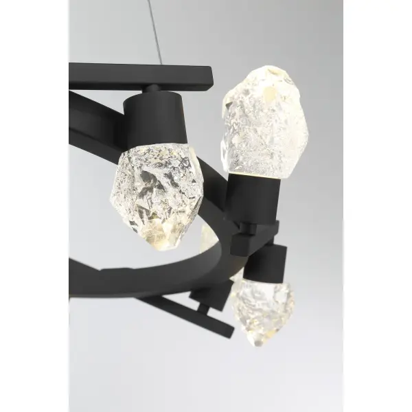 The Kosmyc chandelier combines contemporary design with industrial edge, featuring 12 integrated LED lights and distinctive faux rock crystal accents. Its substantial 33-inch width makes a bold statement in large spaces. - alternate view