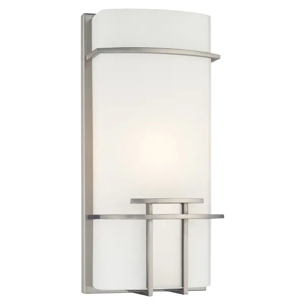 This compact wall sconce combines transitional styling with practical functionality. The brushed nickel finish and glass shade create a clean, versatile look suitable for bathrooms, hallways, and bedrooms. ADA-compliant design ensures accessibility.