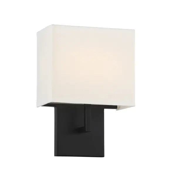 This compact wall sconce combines modern black steel construction with a soft off-white linen shade, delivering 575 lumens of dimmable LED light. ADA-compliant design makes it ideal for accessible spaces while maintaining contemporary style.
