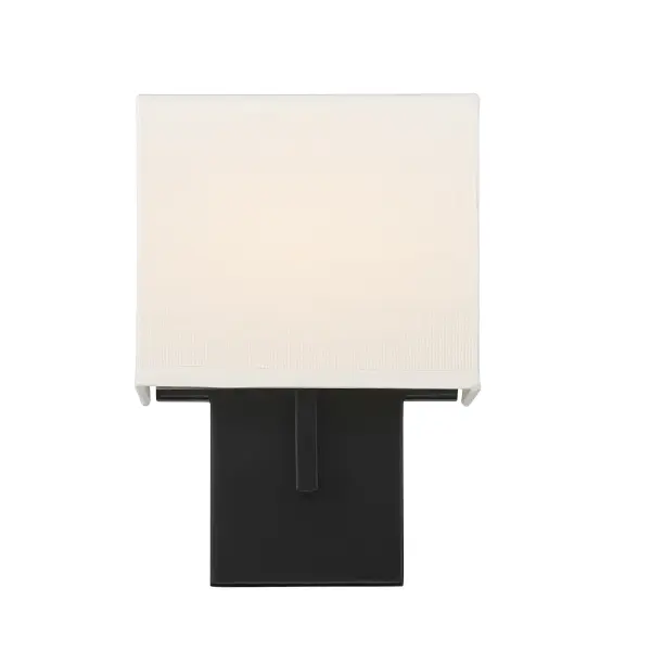This compact wall sconce combines modern black steel construction with a soft off-white linen shade, delivering 575 lumens of dimmable LED light. ADA-compliant design makes it ideal for accessible spaces while maintaining contemporary style. - alternate view