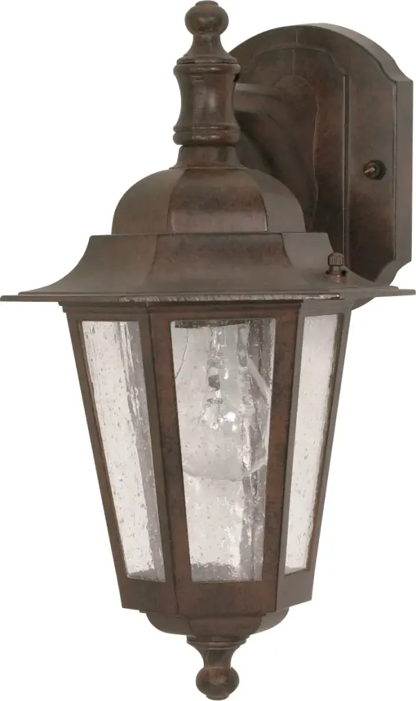 The Cornerstone wall lantern brings traditional outdoor lighting charm with its bronze finish and clear seed glass. At 13 inches, it's perfectly sized for entryways, porches, and patios, offering timeless style and reliable illumination.