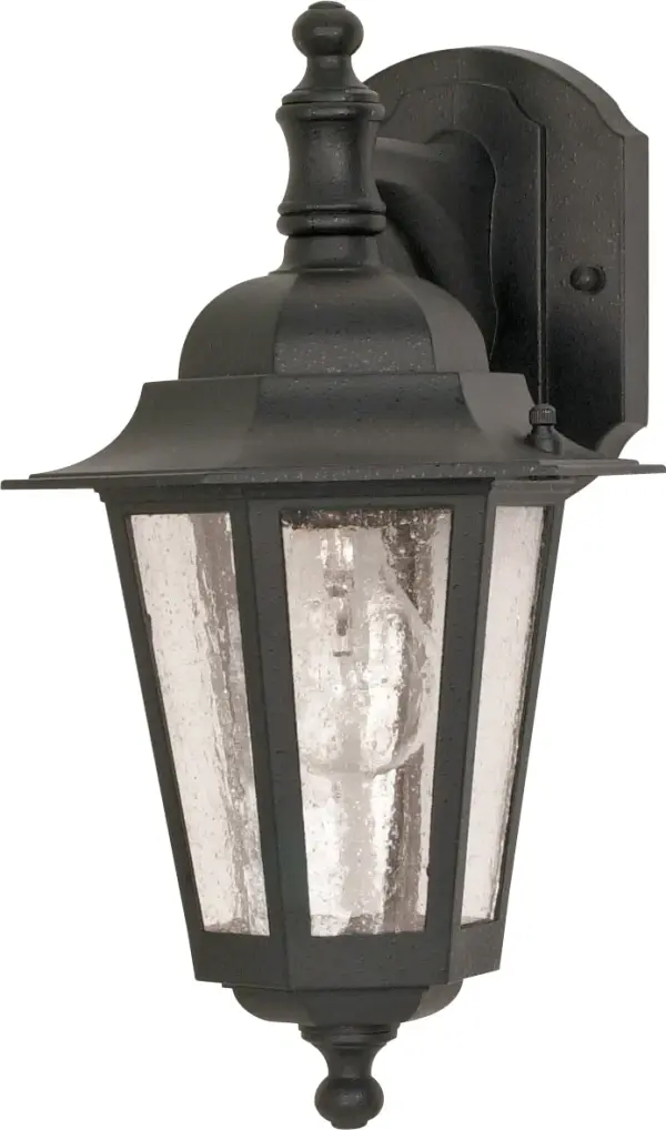 The Cornerstone wall lantern combines traditional styling with practical outdoor lighting. Its black finish and clear seeded glass create timeless curb appeal while the downward-facing design provides functional illumination.