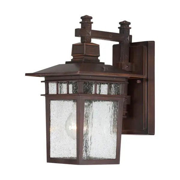 The Cove Neck outdoor wall lantern combines traditional styling with durable construction, featuring clear seeded glass that creates beautiful light patterns. At 12 inches, it's perfectly sized for entryways, porches, and patios.