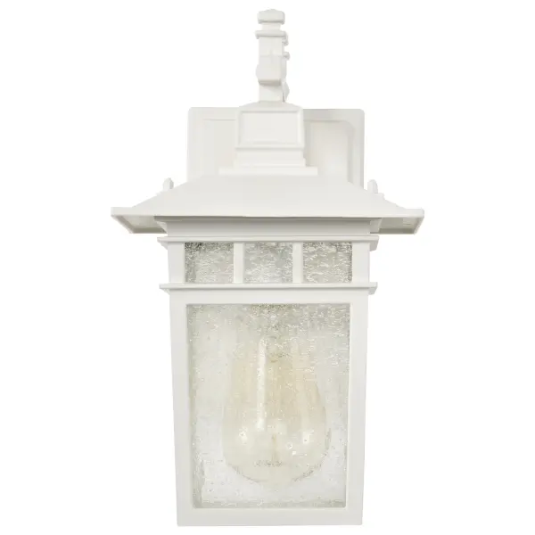 The Cove Neck wall lantern offers a unique fusion of Eastern and American design elements in a compact 12-inch fixture. Its white finish and clear seed glass create a clean, versatile look that enhances curb appeal. - alternate view