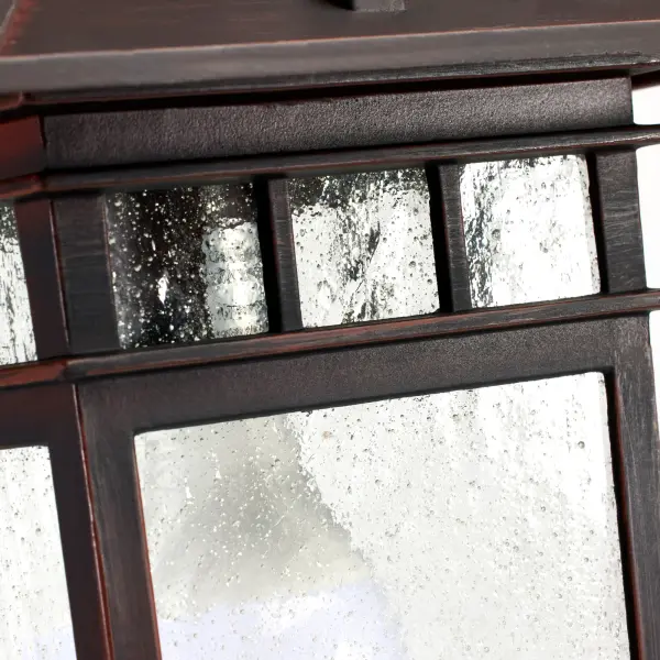 The Cove Neck lantern blends Eastern-inspired design with American farmhouse charm, creating a distinctive outdoor lighting solution. Its rustic bronze finish and clear seeded glass deliver both character and curb appeal. - alternate view