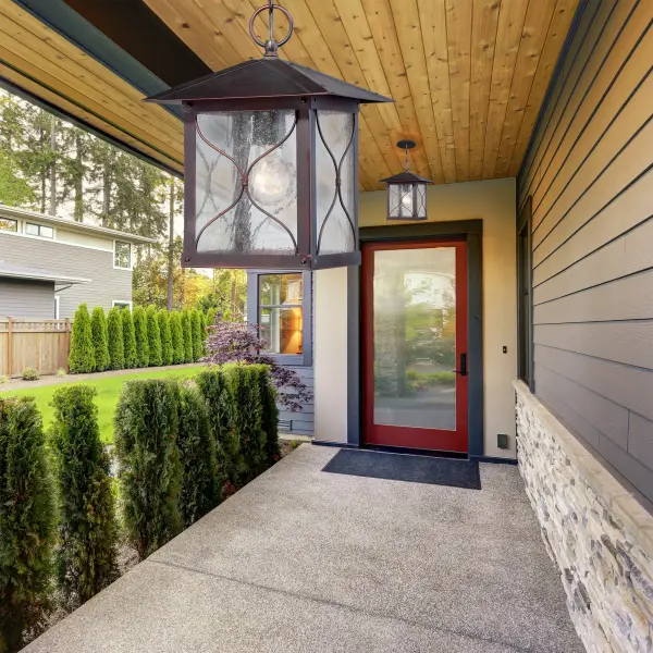The Vega outdoor hanging lantern combines traditional styling with durable construction. Its bronze finish and clear seeded glass create warm, inviting illumination for porches, patios, and entryways. - alternate view