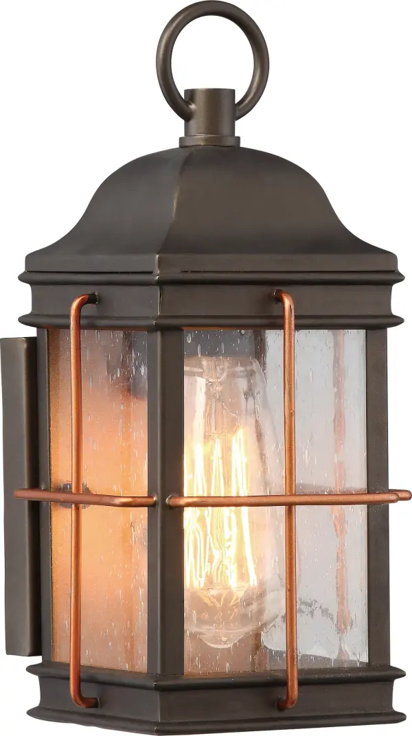 The Howell outdoor wall lantern combines understated elegance with vintage charm. Its bronze finish with copper accents and clear seeded glass create warm, inviting illumination for entryways, porches, and patios.