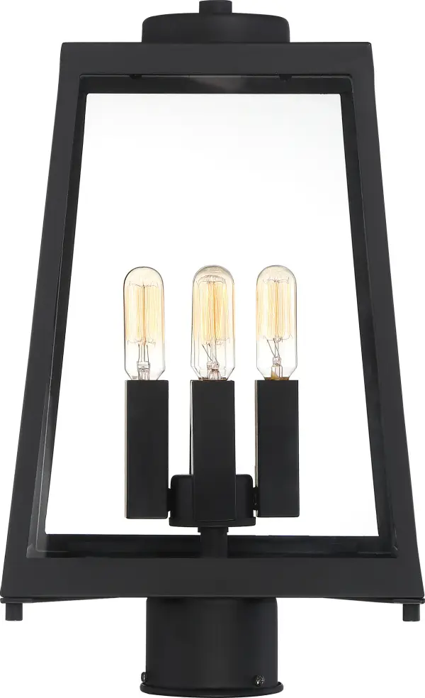 The Halifax post lantern combines modern design with nautical influences, featuring a trapezoidal matte black frame and clear glass panels. Its slightly oversized profile makes a statement while four T9 bulbs provide ample illumination. - alternate view