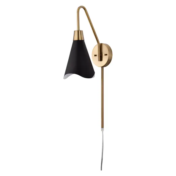 The Tango wall sconce combines matte black metal with burnished brass accents for a sophisticated two-tone look. Its laser-cut wave pattern edge adds subtle visual interest while maintaining clean contemporary lines.