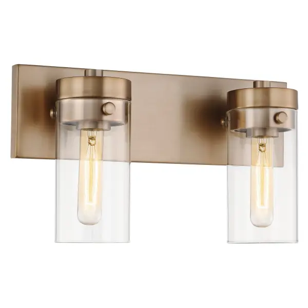 The Intersection vanity fixture blends modern, industrial, and chic design elements with cylindrical clear glass shades that showcase vintage filament bulbs. The rich burnished brass finish adds warmth and pairs beautifully with existing fixtures. - alternate view