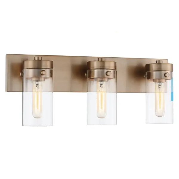 The Intersection vanity fixture blends modern, industrial, and chic design elements with cylindrical clear glass shades that showcase vintage filament bulbs. The rich burnished brass finish adds warmth and pairs beautifully with existing fixtures. - alternate view