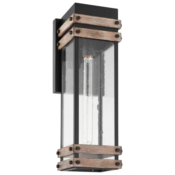 The Homestead wall lantern blends vintage industrial design with farmhouse warmth through its matte black metal cage, wood accents, and seeded glass. Perfect for ranch-style to modern homes seeking authentic outdoor character.