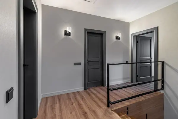 The Clarksville vanity light embodies modern minimalism with its clean lines and sophisticated matte black finish. Clear glass shades allow maximum light output while the slim profile fits seamlessly in any bathroom. - alternate view