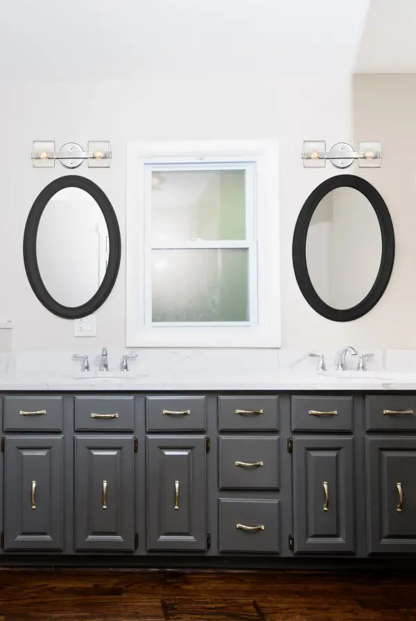 The Marlowe 2-Light Vanity combines contemporary design with timeless elegance. Its polished nickel finish and clear glass shades create a warm, inviting glow perfect for modern bathrooms and powder rooms. - alternate view