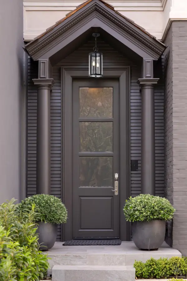 The Broadstone 2-Light Hanging Lantern bridges traditional and contemporary design with its clean matte black finish and textured seeded glass. Perfect for outdoor entryways and covered patios, it creates ambient lighting with visual interest. - alternate view