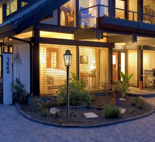 The Lawrence post lantern combines traditional English design with modern versatility. Its matte black finish and clear seeded glass create a warm, welcoming glow perfect for both urban and countryside settings. - alternate view