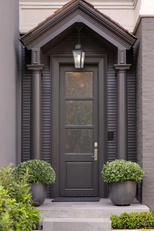 The Lawrence hanging lantern combines traditional English design with modern versatility. Its matte black finish and clear seeded glass create warm, welcoming illumination perfect for greeting guests at any entrance. - alternate view