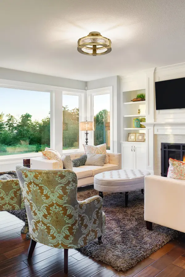 The Darrow semi flush mount combines vintage brass warmth with contemporary design. Its water-effect textured acrylic panels create captivating light patterns, making it perfect for spaces needing both ambient lighting and visual interest. - alternate view
