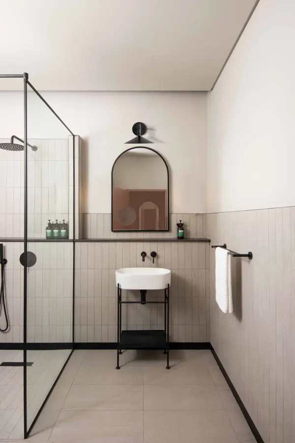 The Corrine wall sconce delivers versatile modern lighting with selectable color temperatures (3K/4K/5K) and energy-efficient LED technology. Its minimalist matte black finish and clean lines make it ideal for contemporary bathrooms and hallways. - alternate view