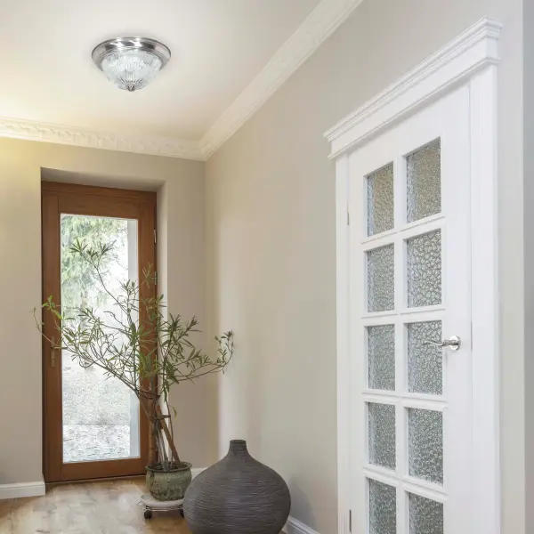 This traditional flush mount combines brushed nickel finish with clear ribbed glass for timeless appeal. Perfect for rooms with standard ceiling heights, it provides functional lighting with decorative charm. - alternate view