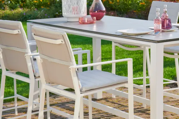 This elegant bar height dining set combines sleek aluminum frames with a sophisticated ceramic top table and comfortable sling bar chairs. Built for outdoor durability with weather-resistant materials and premium construction.