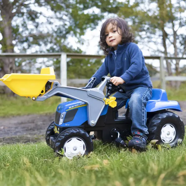 German-engineered pedal tractor with functional front loader and trailer offers realistic play for ages 2.5-5. Features durable resin construction, adjustable chain drive, and pivot steering for safe outdoor adventures. - alternate view
