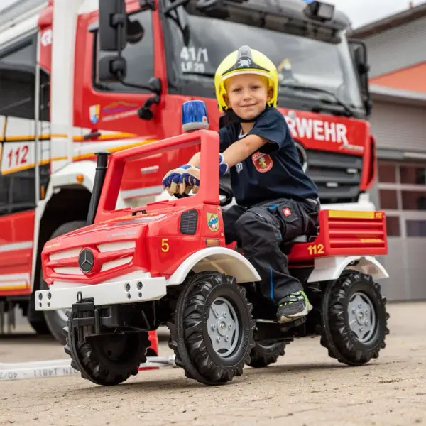 This high-quality Mercedes-Unimog Fire Truck combines authentic design with durable German engineering. Features include rubber tread tires, optimized steering, and protected chain drive for ages 4-8. - alternate view