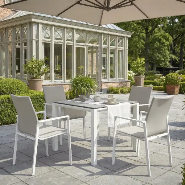 Dine alfresco in style with the Sense Dining Set. The sleek profile of the table and chairs give a clean, contemporary look. The dining chairs feature an aluminum frame with ergonomic arm rests and a comfortable all-weather sling with quick dry foam filling and all weather upholstery fabric. The ceramic top, aluminum frame table is sturdy and weather resistant, ensuring years of outdoor dining enjoyment. Set Includes: (4) Sense Dining Arm Chair (1) 36” Square Concept Dining Table Sense Dining Chair Features: Light-weight powder-coated aluminum construction All-weather soft-touch Textilene fabric cushion for optimal weather resistance and color fastness Padded seat-buckets for maximum comfort and support Durable, all-weather frame and fabric construction Protective, replaceable foot caps prevent marring on any surface and extend the life of the chair No assembly needed Stackable for compact, easy storage Frame color: White Measures: 23"W x 23"D x 34"H, 10lbs Fabric Color: Mouse Grey 36" x 36" Ceramic Dining Table Features: Sturdy powder-coated aluminum construction with stainless steel hardware Maintenance-free ceramic table top is highly scratch-resistant and withstands temperatures ranging from -40°F to 500°F Durable, all-weather frame construction Protective, replaceable foot glides prevent marring on any surface and prolong the life of the table Elegant style lines provide a modern look to any outdoor space Reinforced square frame tubing for added strength Integrated foot levelers prevent wobbling on uneven floors No umbrella hole Minimal assembly needed Measures: 36"L x 36"W x 30"H Frame color: White