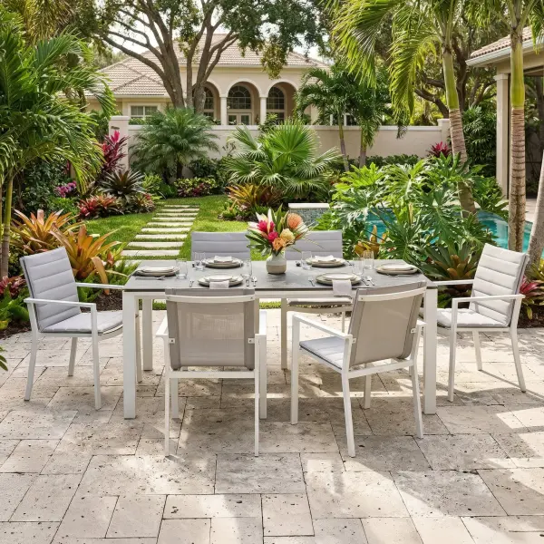 Elevate outdoor dining with the Primavera 7-Piece Dining Set, where refined design meets effortless durability. Six ergonomically contoured sling chairs—crafted with lightweight, powder-coated aluminum frames and breathable, quick-drying acrylic Textilene—offer exceptional comfort, resilience, and stackable convenience, with optional Sunbrella cushions for an added layer of luxury. Paired with the Concept Dining Table, featuring a sleek ceramic top with a sophisticated concrete-look finish, this set delivers both modern elegance and remarkable performance in any climate. In a timeless white and mouse gray palette, Primavera creates a polished, inviting setting for everyday dining and elevated outdoor entertaining. Chair Features: Light-weight powder-coated aluminum construction with stainless steel hardware 100% Acrylic Textilene fabric sling for optimal weather resistance and color fastness Premium, quick-drying sling allows superior drainage Contoured seat and back for maximum comfort and support Frame features full circumference welds for added strength Durable, all-weather frame and fabric construction Integrated arm rests for additional comfort and style Protective, replaceable foot caps prevent marring on any surface and extend the life of the chair Stackable for compact, easy storage Frame | Sling Color: White/Mouse Gray Optional Sunbrella Cushion available in Grey Chine Fabric Table Features: Elegant style lines provide a modern look to any outdoor space Robust powder coated aluminum construction with stainless steel hardware Frame features full circumference welds for a durable, all-weather frame Durable ceramic top with concrete look finish can withstand temperatures ranging from -40°F to 500°F Durable, all-weather frame construction Protective, replaceable foot glides prevent marring on any surface and prolong the life of the table Integrated foot levelers prevent wobbling on uneven floors No umbrella hole Frame Color: White Top Color: Concrete Look - alternate view