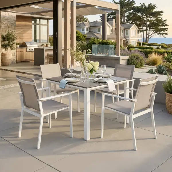 Elevate outdoor dining with the Primavera 5-Piece Dining Set, where refined design meets effortless durability. Four ergonomically contoured sling chairs—crafted with lightweight, powder-coated aluminum frames and breathable, quick-drying acrylic Textilene—offer exceptional comfort, resilience, and stackable convenience, with optional Sunbrella cushions for an added layer of luxury. Paired with the Concept Dining Table, featuring a sleek ceramic top with a sophisticated concrete-look finish, this set delivers both modern elegance and remarkable performance in any climate. In a timeless white and mouse gray palette, Primavera creates a polished, inviting setting for everyday dining and elevated outdoor entertaining. Chair Features: Light-weight powder-coated aluminum construction with stainless steel hardware 100% Acrylic Textilene fabric sling for optimal weather resistance and color fastness Premium, quick-drying sling allows superior drainage Contoured seat and back for maximum comfort and support Frame features full circumference welds for added strength Durable, all-weather frame and fabric construction Integrated arm rests for additional comfort and style Protective, replaceable foot caps prevent marring on any surface and extend the life of the chair Stackable for compact, easy storage Frame | Sling Color: White/Mouse Gray Optional Sunbrella Cushion available in Grey Chine Fabric Table Features: Elegant style lines provide a modern look to any outdoor space Robust powder coated aluminum construction with stainless steel hardware Frame features full circumference welds for a durable, all-weather frame Durable ceramic top with concrete look finish can withstand temperatures ranging from -40°F to 500°F Durable, all-weather frame construction Protective, replaceable foot glides prevent marring on any surface and prolong the life of the table Integrated foot levelers prevent wobbling on uneven floors No umbrella hole Frame Color: White Top Color: Concrete Look