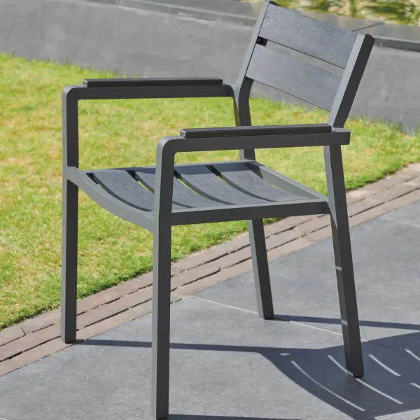 The Torino Arm Chair combines contemporary design with practical functionality. Featuring a sturdy aluminum frame and contoured poly slats, this stackable chair offers comfort and durability for both residential patios and commercial outdoor spaces. - alternate view
