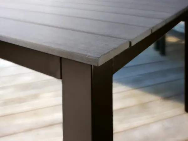 The Bretange Dining Table offers exceptional durability with its powder-coated aluminum frame and 100% recycled resin slat top. Perfect for both indoor and outdoor use, it seats up to 8 guests and features an integrated umbrella hole. - alternate view