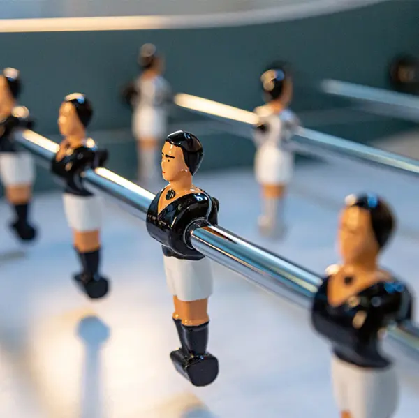 Handcrafted in France, this premium foosball table combines tournament-quality play with contemporary aesthetics. Features durable Gerflex playfield, telescopic rods, hand-painted aluminum players, and menthe lacquer finish. - alternate view