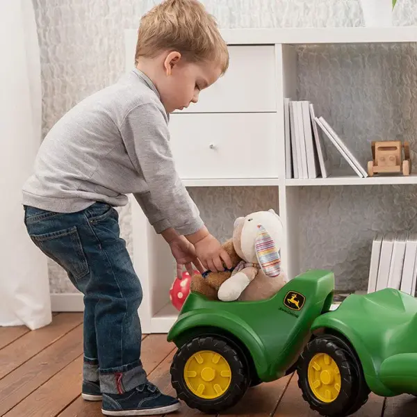 This John Deere Minitrac Trailer a ttaches to the back of the Rolly Minitrac ride-on for additional play value. High impact blow molded resin body Attaches to the back of the Minitrac for additional play 3 Year Residential Limited Manufacture defect Wipes Clean Manufactured by Rolly Toys Made in Germany MADE TO GO WITH: John Deere Minitrac Foot To Floor Ride-On - alternate view
