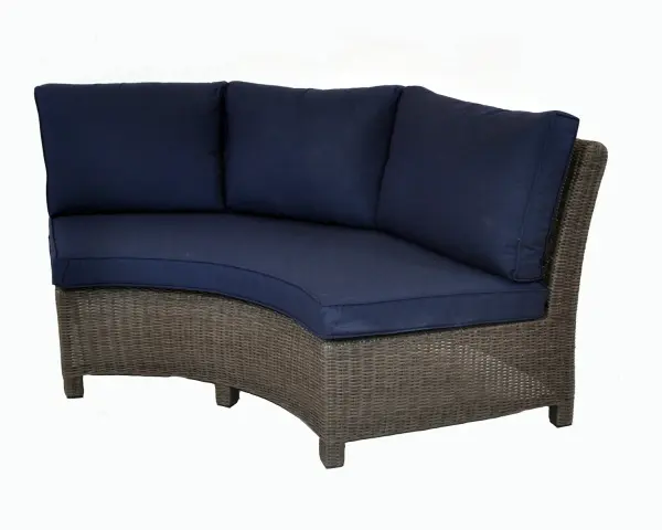 The Palma Wicker Curved Sofa combines dining and relaxation in one elegant piece. Handwoven weatherproof wicker over powder-coated aluminum creates durability, while 4-inch Sunbrella cushions ensure comfort and weather resistance.